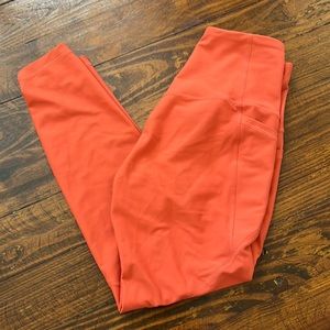 Orange athletic leggings with pockets